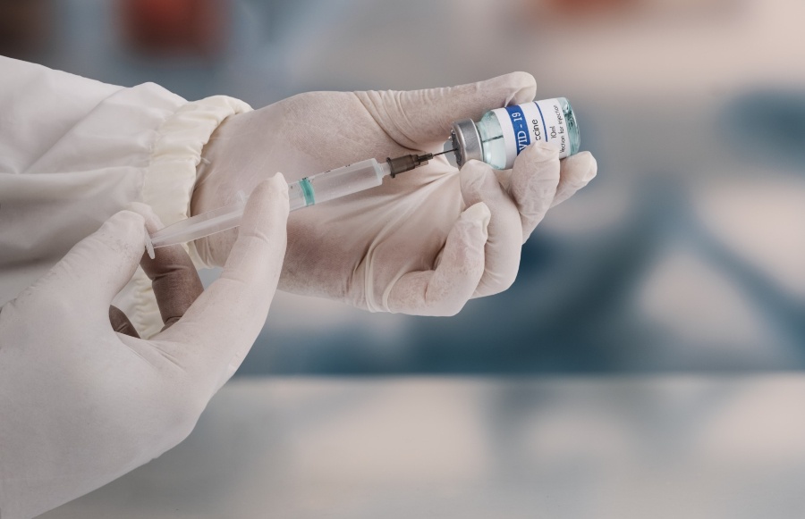 Image of a doctor holding a vaccine, illustrating the importance of healthcare for expats in Panama.