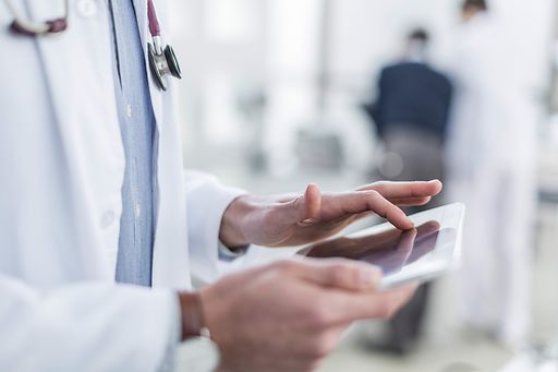 Image of a doctor holding an iPad, representing the modern healthcare facilities available for expats in Panama
